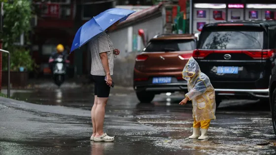 Mamma e figlia in strada sotto la pioggia