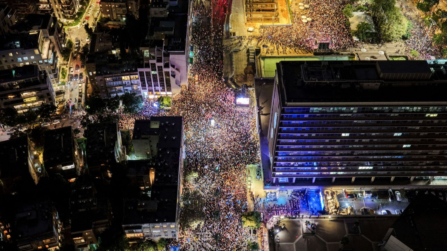 Nella fotografia, presa dall'alto da un drone, si vedono centinaia di migliaia di israeliani radunati di sera in Piazza Rabin a Tel Aviv per ricordare i 30 anni dall'assassinio del premier Yitzhak Rabin