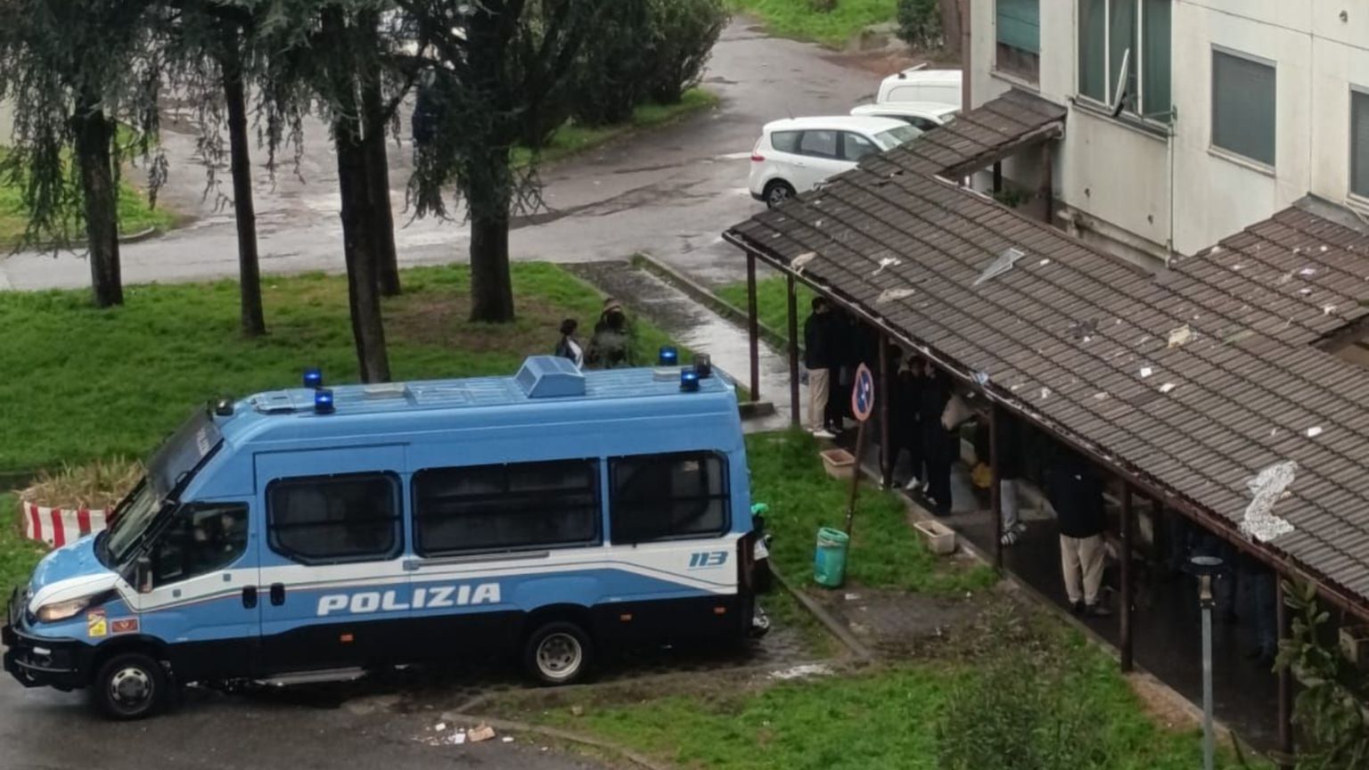 Una camionetta della polizia all'esterno del palazzo di via Quarti, 31 a Milano, dove è stata eseguita l'ordinanza di sgombero