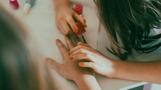 Una bimba gioca a fare lo smalto a una sua amichetta