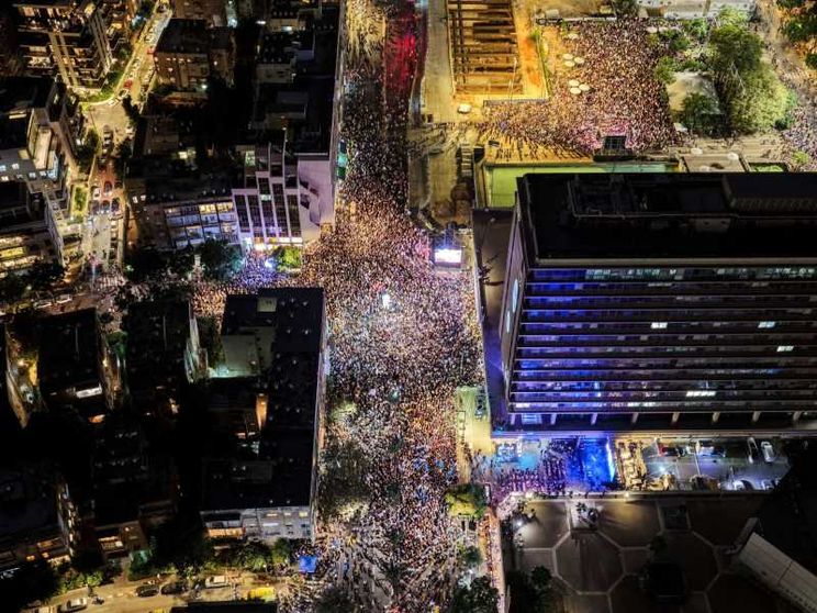 Nella fotografia, presa dall'alto da un drone, si vedono centinaia di migliaia di israeliani radunati di sera in Piazza Rabin a Tel Aviv per ricordare i 30 anni dall'assassinio del premier Yitzhak Rabin