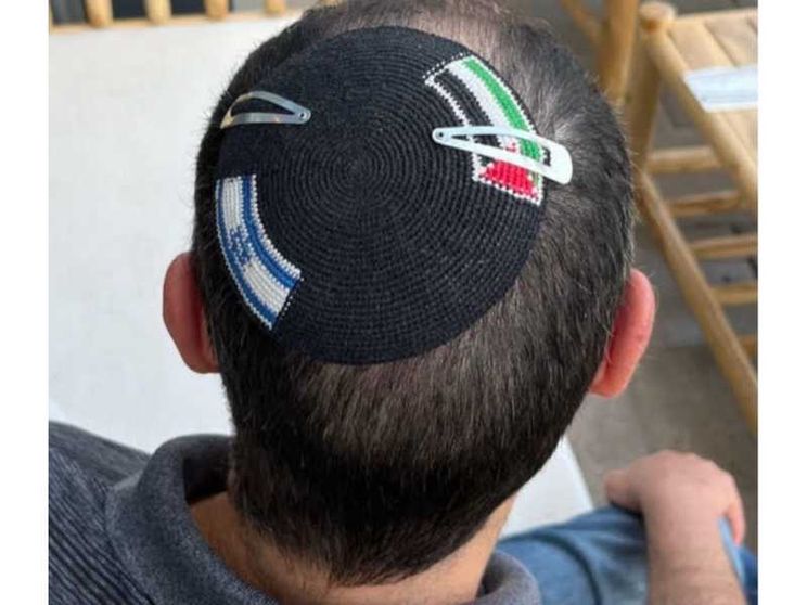 Una kippà con due bandiere: israeliana e palestinese