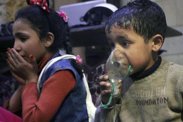 Una foto diffusa l'8 aprile dai White Helmets siriani: due bimbi ricevono ossigeno dopo un presunto attacco chimico a Duma (Ansa)