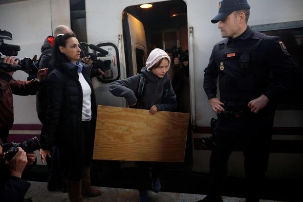 Greta Thunberg scende dal treno Lusitania alla stazione di Madrid (Ansa)