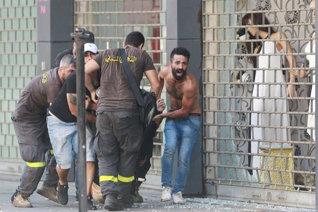 Beirut. Un ferito viene portato via dal luogo della sparatoria