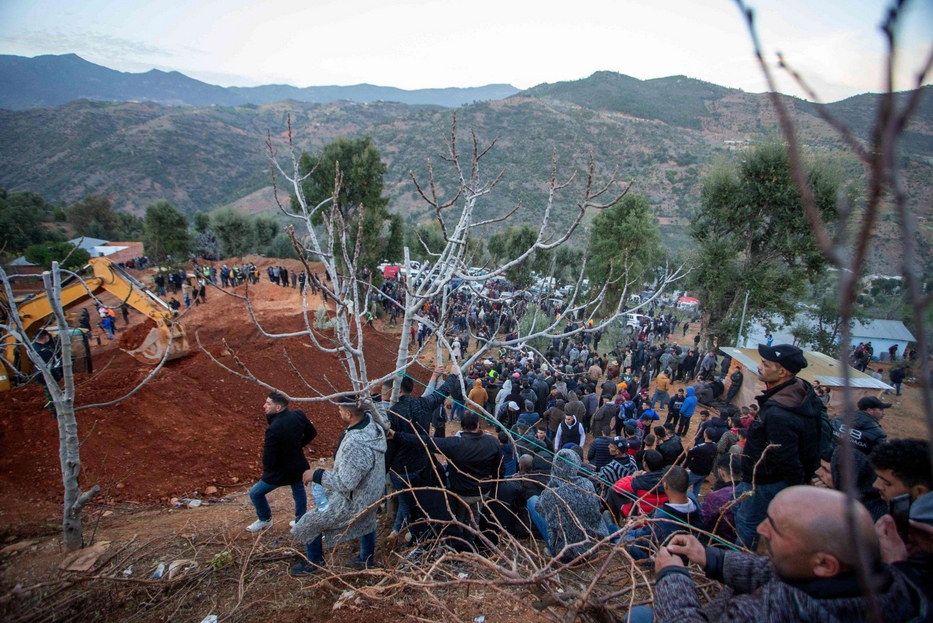 La gente assiepata attorno allo scavo a Tamrout, vicino Chefchauen, in Marocco