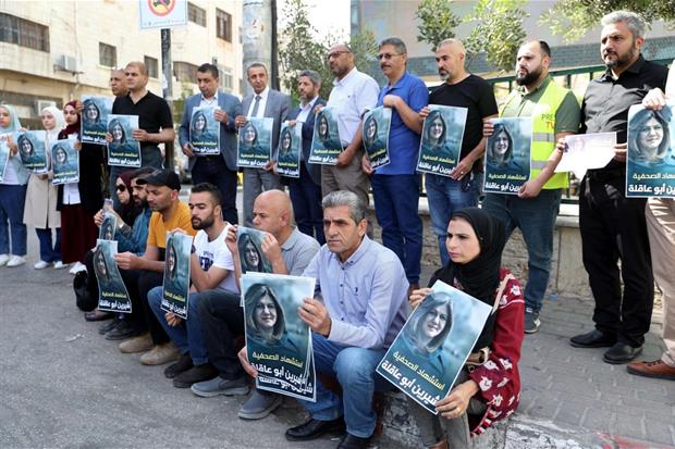 A Hebron le proteste da parte di giornalisti palestinesi che tengono tra le mani un ritratto della giornalista uccisa a Jenin