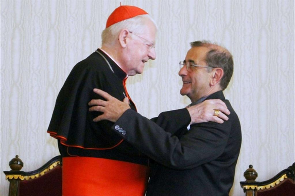 L'abbraccio tra monsignor Delpini e il cardinale Scola (Fotogramma)