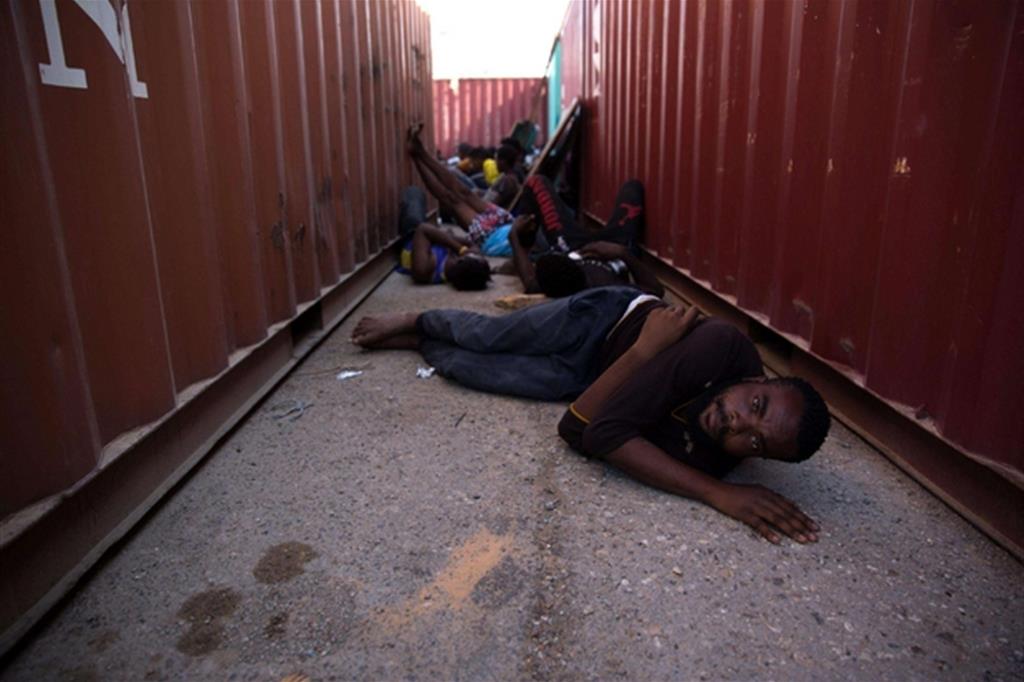 Ragazzi nel porto di Tripoli in attesa di essere portati in un centro di detenzione libico (Ansa)