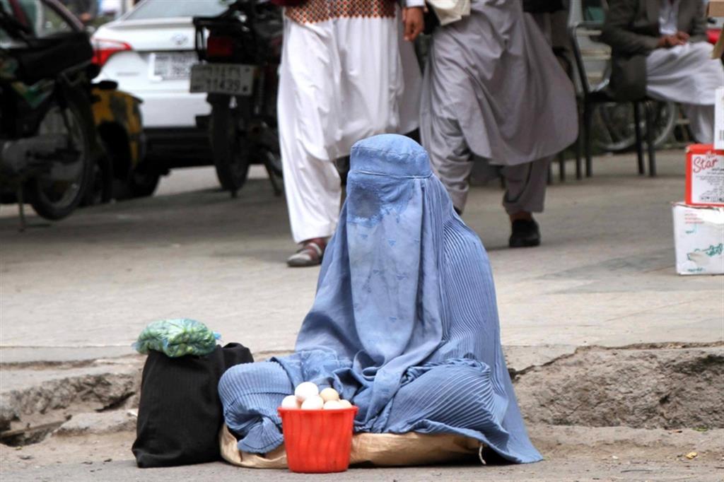 Una donna vende i suoi prodotti in strada ad Herat