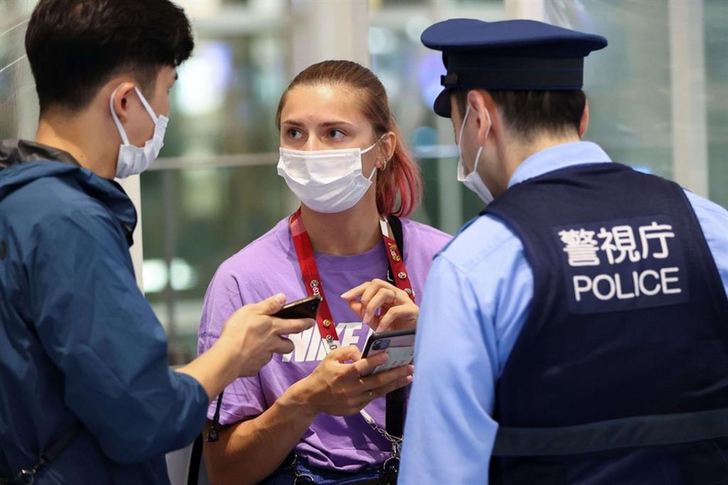 La velocista Krystsina Tsimanouskaya parla con la polizia all'aeroporto internazionale Haneda a Tokyo