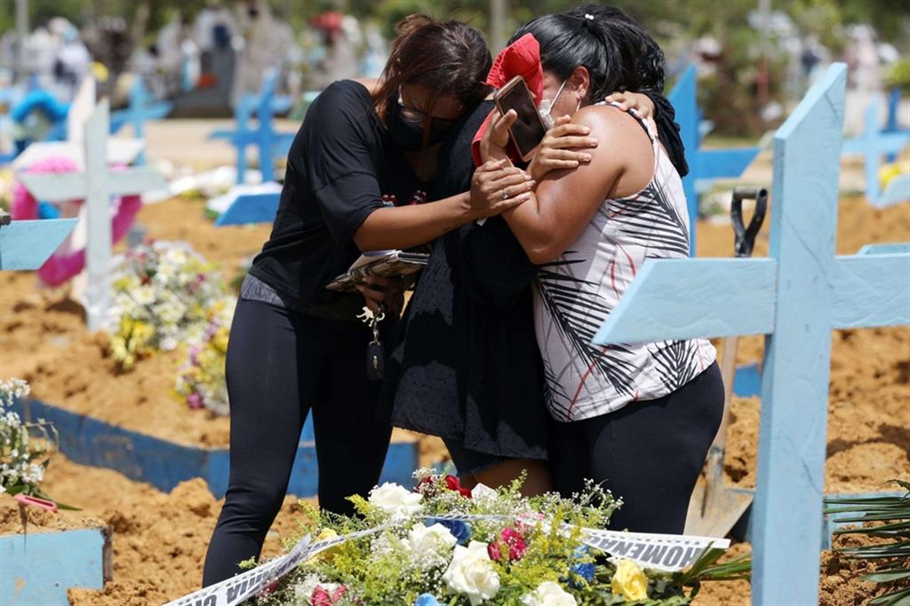 I parenti di una vittima del Covid in lacrime al cimitero di Manaus