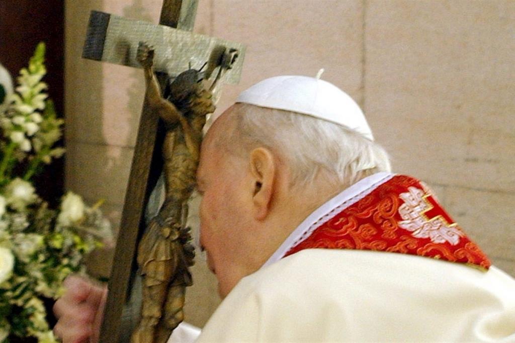 Giovanni Paolo II nella sua cappella privata, abbracciato al legno della Croce nel venerdì della Passione di Gesù durante la Via Crucis del Colosseo. Otto giorni dopo sarebbe morto