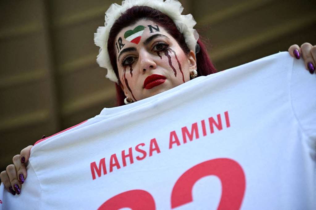 Una ragazza ricorda la giovane curda Mahsa Amini, “punita” dalla polizia morale iraniana perché aveva indossato l'hijab ma lasciando fuori ciocche di capelli