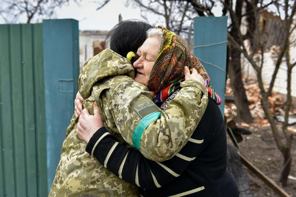 Un abbraccio consolatorio tra due donne ucraine nel villaggio di Andriivka, nell’area di Kiev