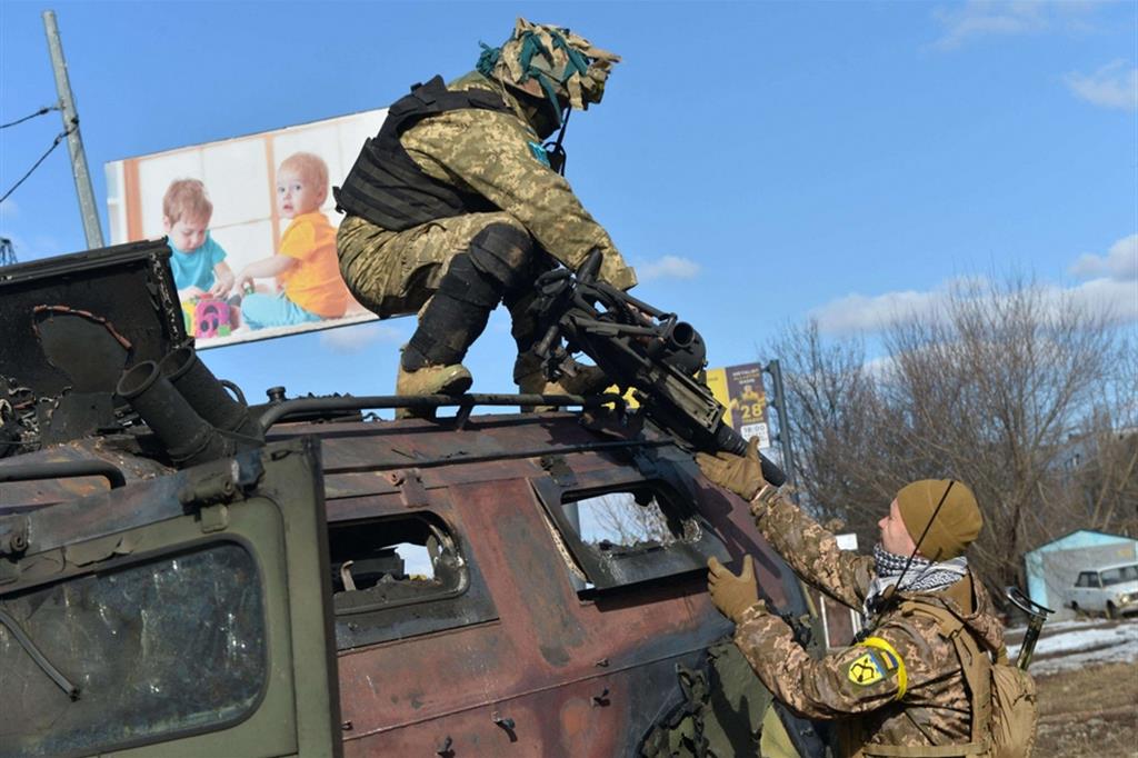 Combattenti della Difesa territoriale ucraina prende un lanciarazzi da un tank russo distrutto