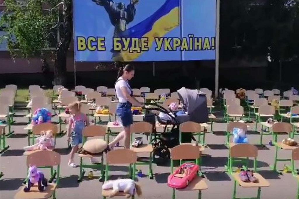 In un fermo immagine tratto da un video pubblicato dalle forze armate ucraine il requiem per i bambini morti dell'Ucraina a Dobroslavska nella regione di Odesa, 1 giugno 2022.. La gente del posto ha mostrato i giocattoli dei bambini sulle sedie della scuola
