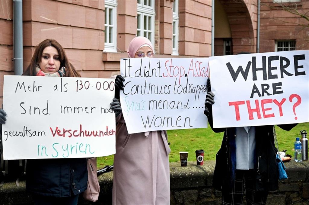 Women protest outside the High Regional Court of Koblenz after the sentence that sentenced the torturer of Damascus to life imprisonment