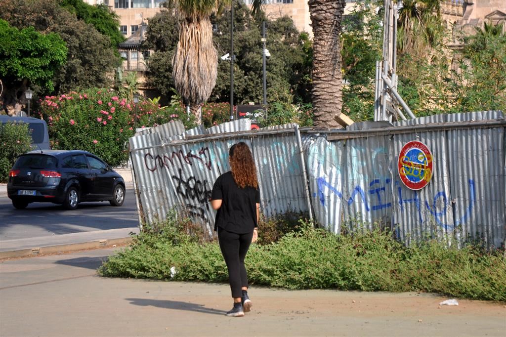 Una ragazzina cammina davanti al cantiere dove è stata stuprata la ragazza di Palermo, lo scorso 7 luglio
