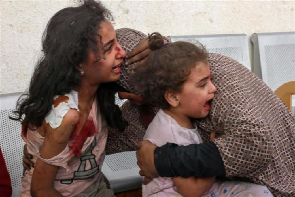 Una madre a Gaza consola le due bambine terrorizzate