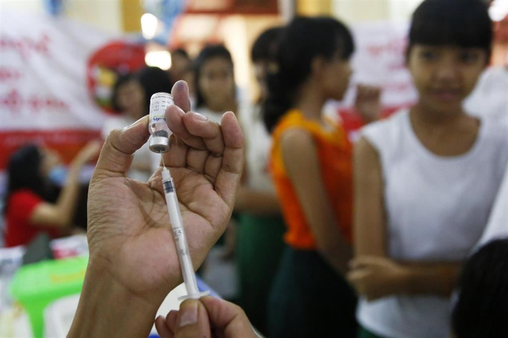 Un sanitario impegnato nella preparazione di una dose di vaccino contro l’encefalite nella città di Yangon, in Myanmar