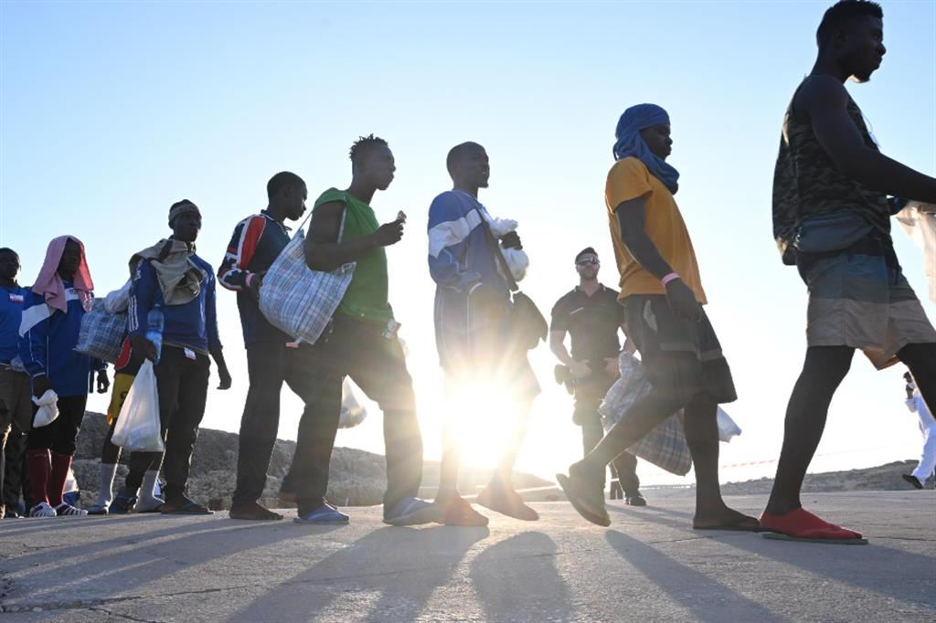 Migranti a Lampedusa in attesa di essere trasferiti