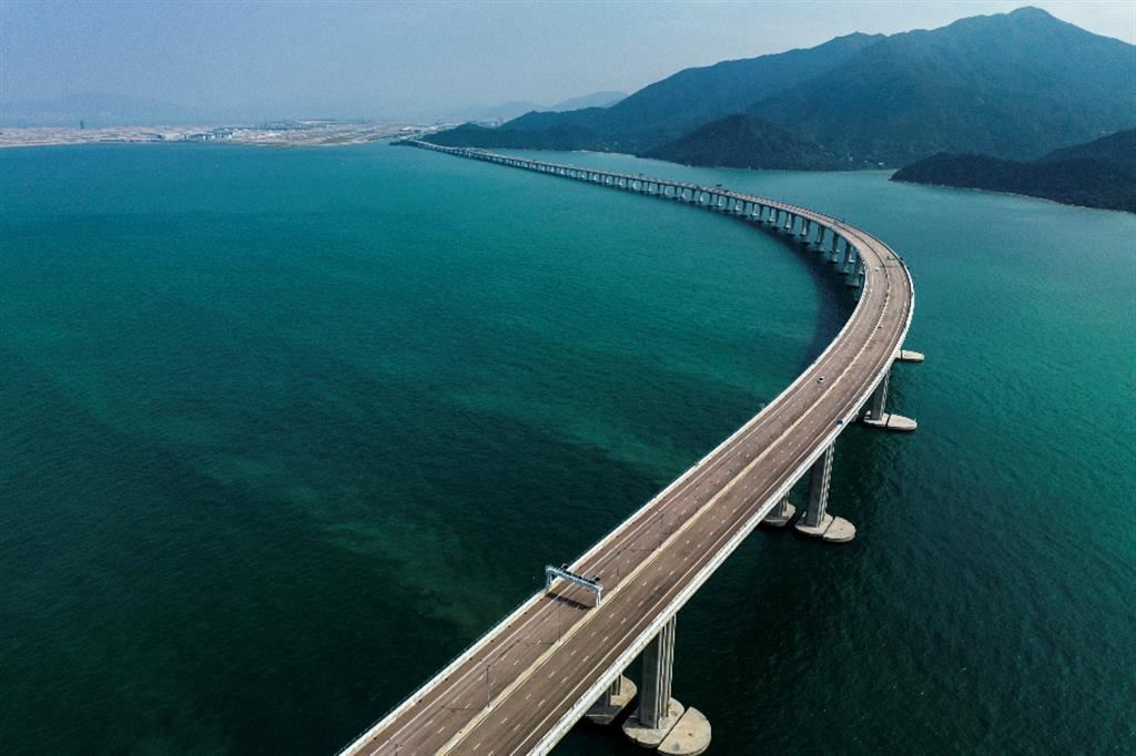 Innovazione, imprese e infrastrutture. Nella foto il ponte di Hong Kong Zhuhai-Macao, lungo 55km, il  più imponente al mondo non solo per lunghezza, ma anche per l’innovazione vista la portata e l’impianto della galleria marittima. La nota città asiatica ospita oggi 7,4 milioni ed è in continua espansione. Per questo il governo  cinese ha annunciato negli ultimi anni un piano ambizioso volto a favorire la mobilità sostenibile. A partire dal trasporto ferroviario, passando da quello cittadino, fino alla costruzione del ponte lungo 55 km. Hong Kong è oggi una città all’avanguardia come dimostrato dall’ambizioso progetto  Smart City Blueprint suddiviso su 6 aree di azione: (qualità della vita, Ambiente, Mobilità, Persone,  Istituzioni e Economia) e 76 progetti di grandi opere - BG4SDGs – Time to Change / Stefano Guidani
