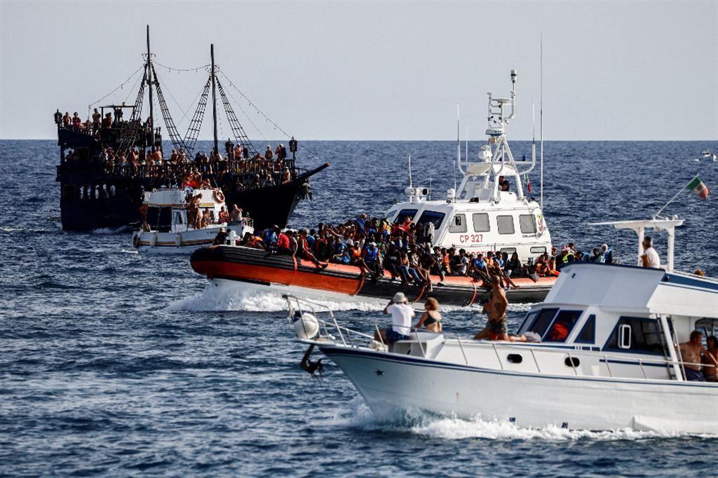 Lampedusa, natante della Guarda Costiera con a bordo migranti passa tra un veliero turistico e uno yacht