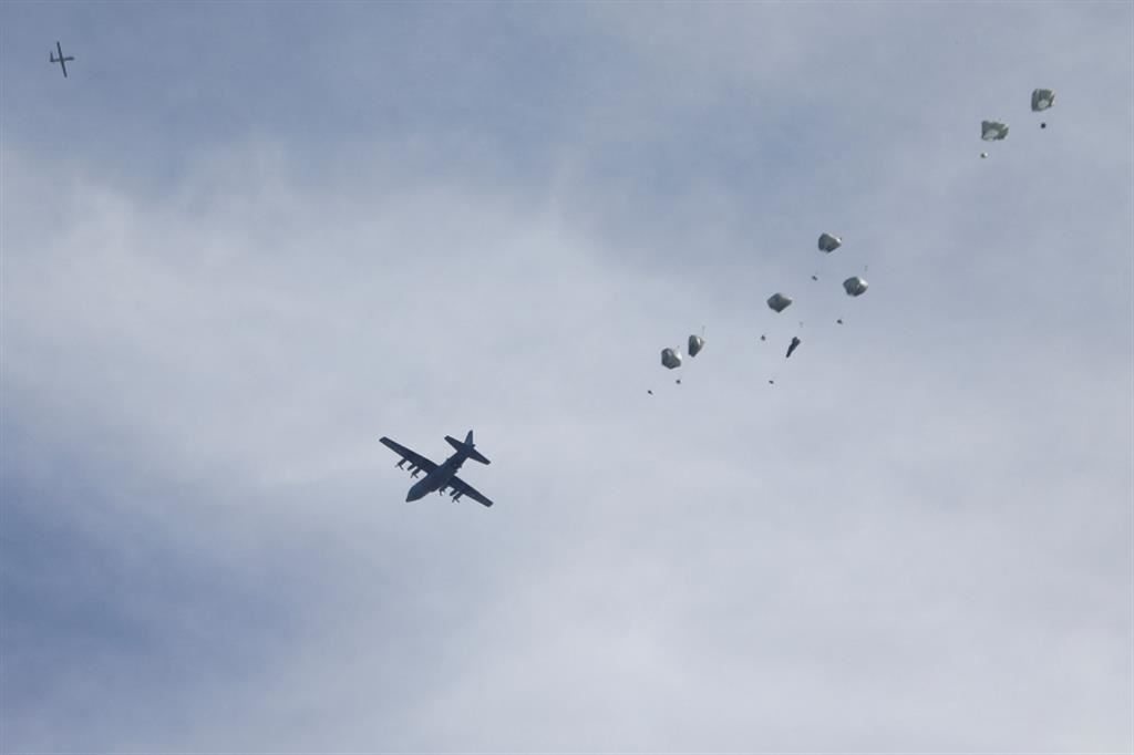 Un aereo militare lancia pacchi di aiuti con il paracadute nel cielo di Gaza