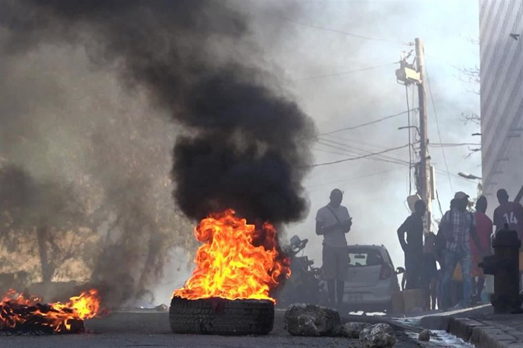 Rogo di pneumatici vicino alla prigione di Port-au-Prince dopo l'evasione in massa di migliaia di membri delle gang criminali che controllano la capitale